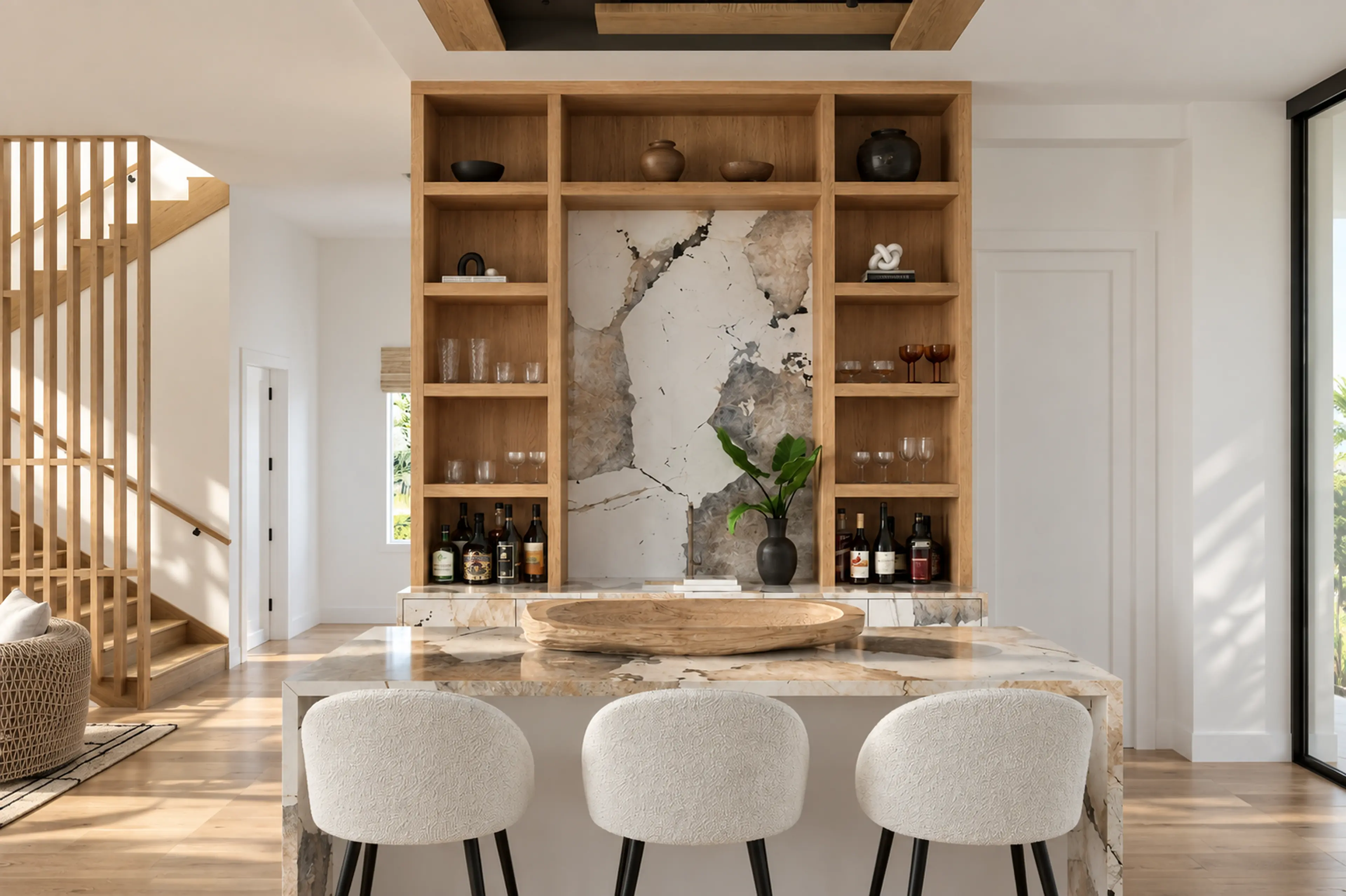 Built-in oak bar with veined stone and ivory stools in a renovated Highland Beach condo.